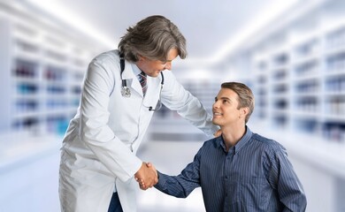 Young smart doctor with patient consulting in hospital.