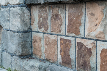 A Rustic Stone Wall with Textured Blocks and Subtle Color Variation