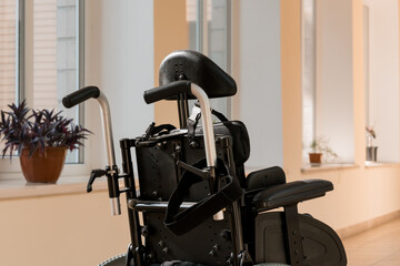 A Modern Wheelchair Resting in a Serene Indoor Space with Natural Light