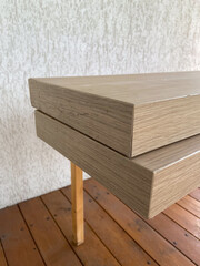 Stacked wooden planks display an exquisite blend of natural texture and modern design. Warm tones and linear grain pattern bring elegance and simplicity to this architectural detail