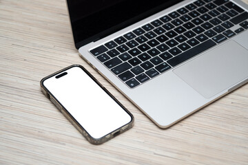 Smartphone with White Screen Mockup Next to Laptop © Kamil