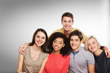 Portrait of young happy friends students posing