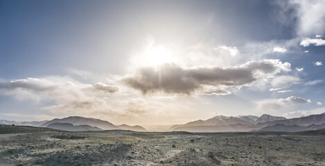 Panoramic landscape of textured Tien Shan mountains in Pamir in Tajikistan, panoramic landscape of a mountain range with snow and glaciers in summer