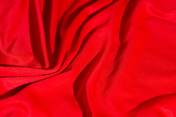 selective focus Luxurious fabric texture of red silk or wavy satin can be used as abstract background, top view