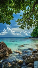 Obraz premium Tropical Beach Seascape with Green Foliage and Blue Sky