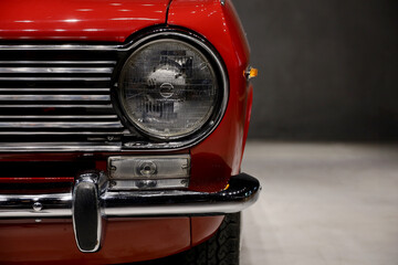 Headlights and front grille of a 60s car