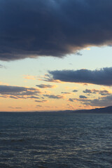 Sunset at sea. Balearic Sea, Salou, Spain. Beach, sea, small waves. Evening landscape on the coast. Vacation at sea