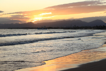Sunset at sea. Balearic Sea, Salou, Spain. Beach, sea, small waves. Evening landscape on the coast....