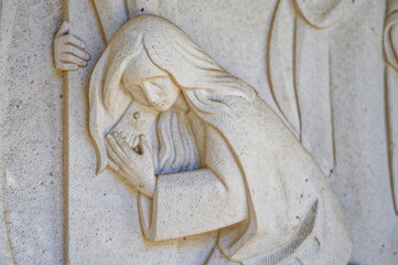 Mary Magdalene at the foot of the cross. Jesus dies on the cross – Station XII of the Way of the Cross. Valinhos (Fátima), Portugal.