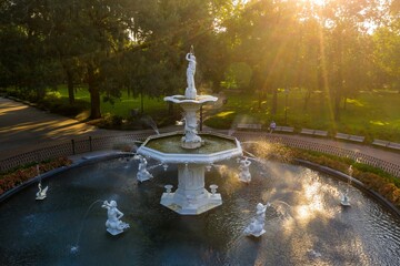 Oak trees and Fountain at Forsyth Park at sunrise. Savannah, Georgia, United States.