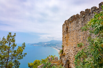 Landscape view old walls of fortress on Mediterranean coast. View of Alanya Castle, stone ruins in harbor Alanya, Turkey. High quality photo