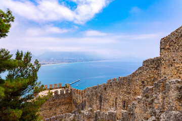 Landscape view old walls of fortress on Mediterranean coast. View of Alanya Castle, stone ruins in harbor Alanya, Turkey. High quality photo