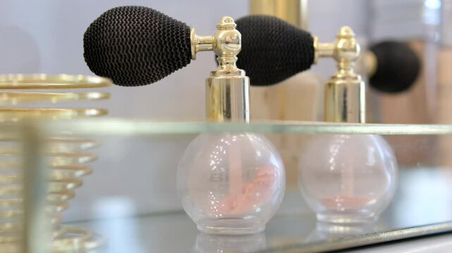 Luxury golden perfume bottle and shining light flares on pink background, glamorous fragrance scent as perfumery product for cosmetic and beauty brand. perfume bottles