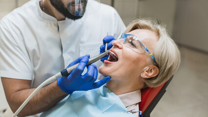 Male orthodontist checkup. Perfect ideal healthy smile. Stomatological dental equipment, dentist...