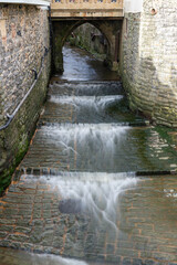 Long exposure of the mouth of the river Lim flowing into the sea at Lyme Regis in Dorset