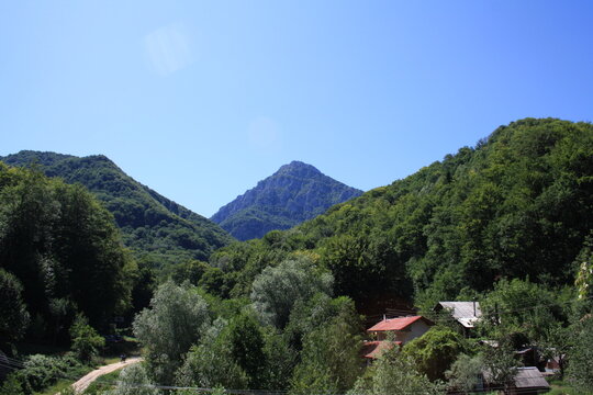 Scenic Mountain Landscape of Kozuf mountain with Green Forest and Rural Houses
