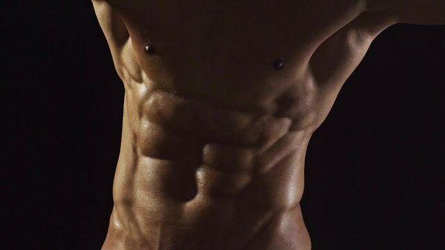 Cropped video of fit man showing six pack abs. Perfect abs, shoulders, and chest. Close up the Abs. Closeup torso. Ab. Muscular torso and ripped abs. Sexy male muscular body.