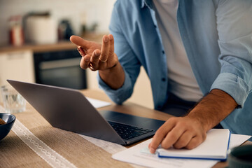 Close up of man communicating during video call at home.