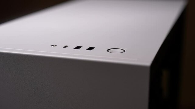 Close-up hands of unrecognizable PC user pressing power button on white desktop computer, starting up device for work or home use. Concept of modern technology for internet access, communication.