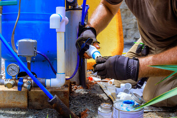 Plumbing work assembling connection between water well water system at house