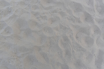 Close-up view of a sandy surface with patterns
A close-up of dry sand scattered by the wind, with soft waves and texture. A natural background that evokes thoughts of warm summer and vacations.
