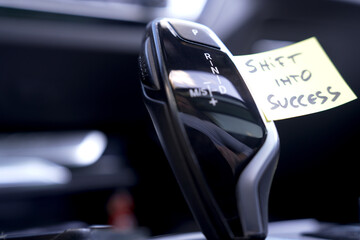 a sticker on a gear shifter that says Shift into Success