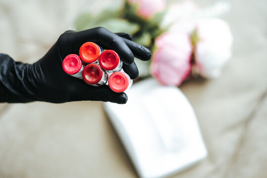 Cosmetologist Holding Permanent Makeup for Lips