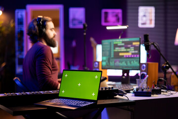 Audio engineer adding sound effects on tunes by using daw software interface, editing music next to...