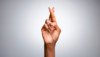African-American woman's hand with her fingers crossed