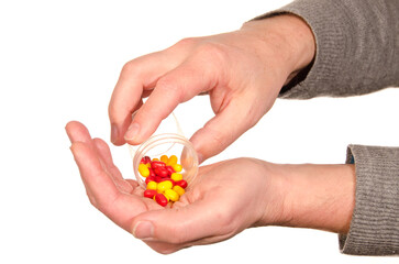 Closeup on man's hands with pills and pill container.