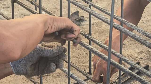 metal frame reinforcing building structure, worker installing steel frame.