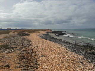 Shell Cemetery Beach, Santa Maria, Sal, Cape Verde, Africa: Beach made of shells next to the sea, cloudy