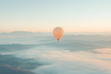 Fototapeta premium Hot Air Balloon Soaring Over Misty Mountains at Sunrise