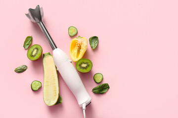 Modern blender with fruits and vegetables on pink background
