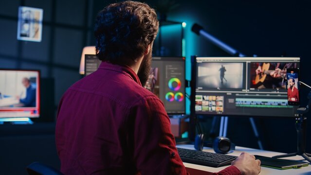 Video editor using smartphone to film tutorial on how to polish raw footage and apply modern editing techniques. Videographer recording internet guide on professionally adjusting clips