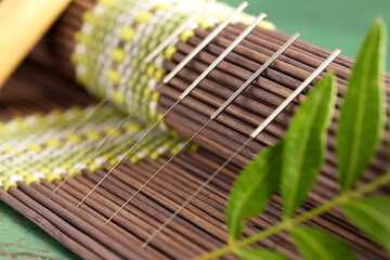 Acupuncture needles on bamboo mat, closeup