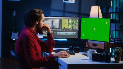 Video editor analyzing film montage on green screen monitor before editing color grading and...