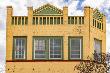 Fototapeta premium Yellow and green painted brick bulding.