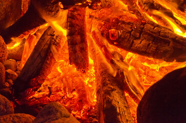 glow wood in fireplace close up with flame