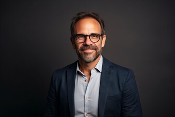 Handsome middle aged man with eyeglasses, studio portrait