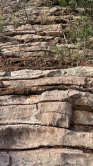  A close-up of horizontal layers of rock showing the natural patterns and textures of the rock.