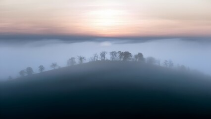 Obraz premium Fog-Shrouded Hill at Dawn