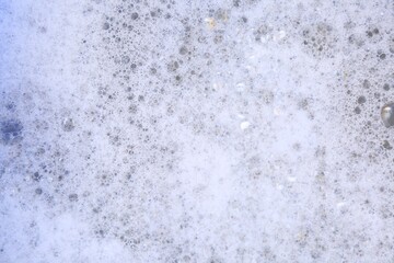 Detergent foam as background, top view. Hand washing laundry