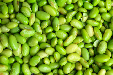 Fresh edamame beans as background, top view