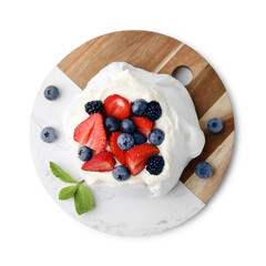 Pavlova cake (meringue dessert) with whipped cream, fresh berries and mint isolated on white, top view