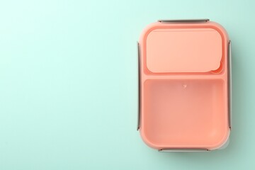 One empty lunch box on light blue background, top view. Space for text