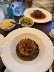 Handmade savory pies at a sophisticated dinner setting, in a London, UK, England restaurant.