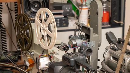 A vintage camera with a film reel and a modern camera with a video tape video head
