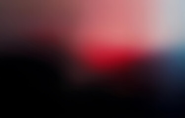 Obraz premium A blurry background with a gradient of red, pink, and blue, transitioning into black.