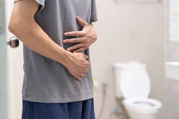 Constipation and diarrhea in bathroom. Hurt man touch belly  stomach ache painful. colon...